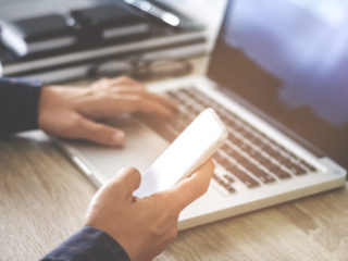 man using mobile smartphone shopping online with laptop, payment and marketing concept