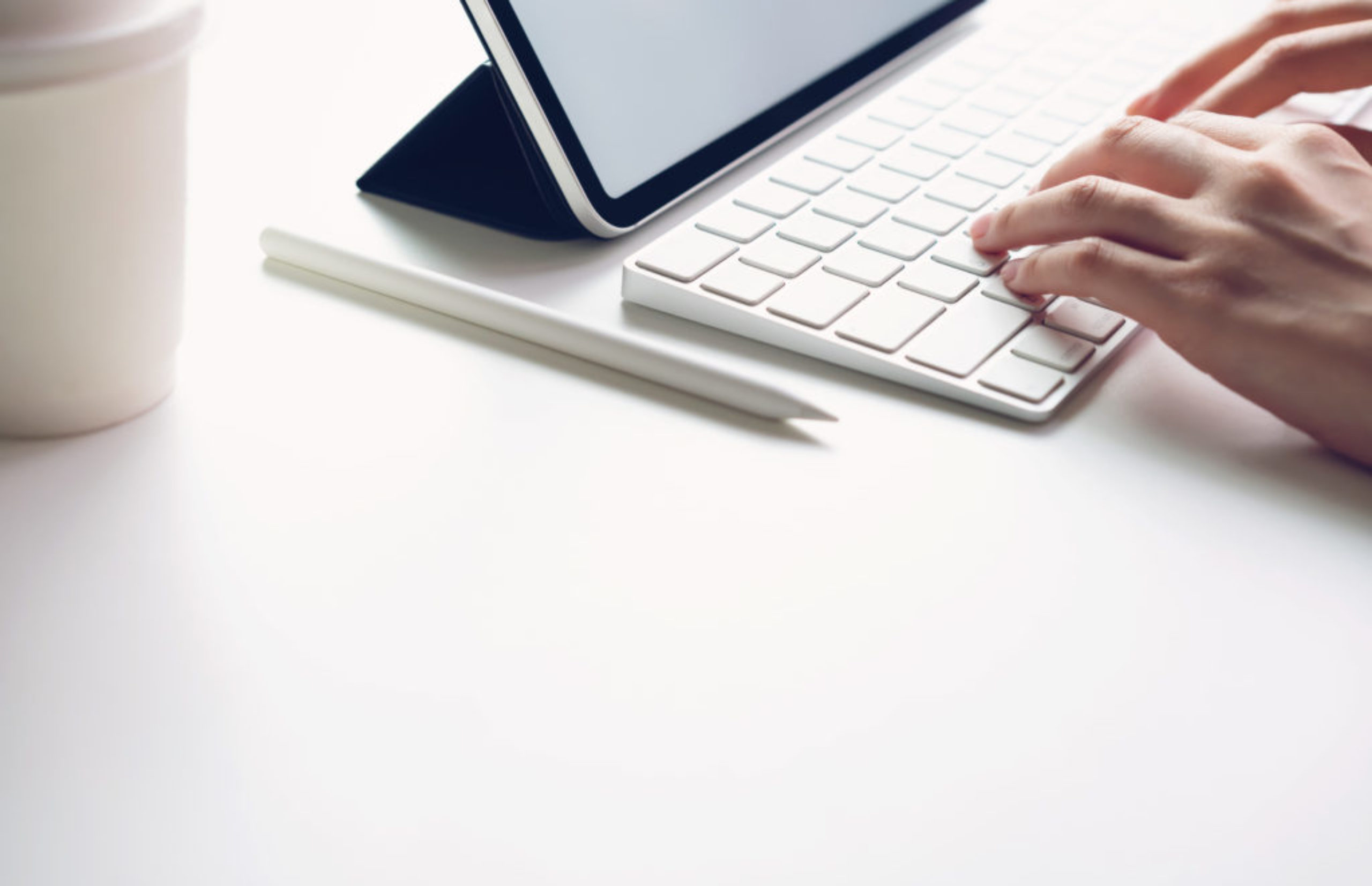 Woman typing keyboard laptop and tablet screen blank on the table mock up to promote your products. Concept of future and trend internet for easy access to information.