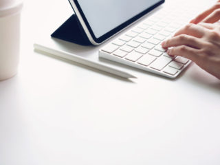 Woman typing keyboard laptop and tablet screen blank on the table mock up to promote your products. Concept of future and trend internet for easy access to information.