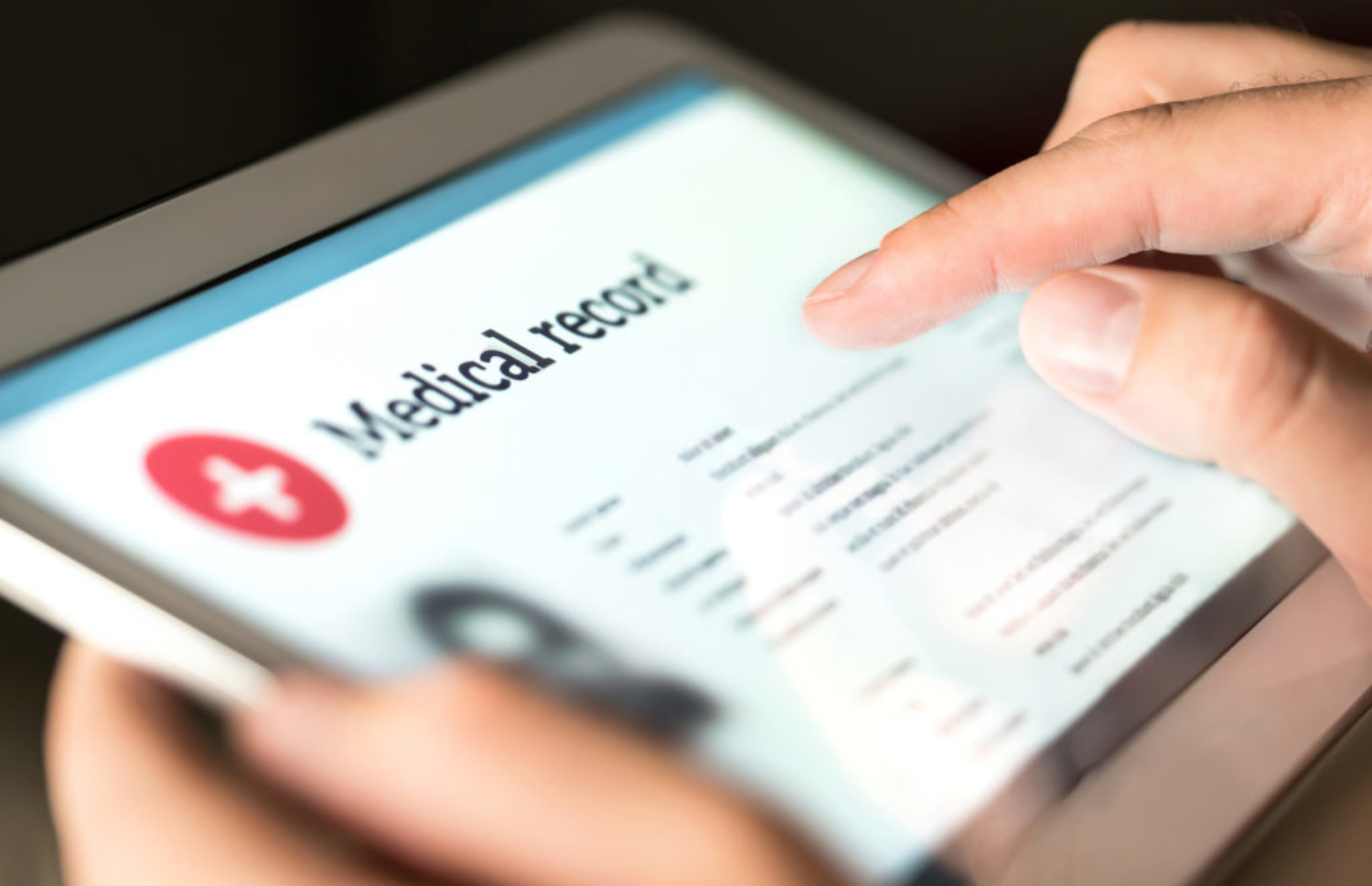 Electronic medical record with patient data and health care information in tablet. Doctor using digital smart device to read report online. Modern technology in hospital.